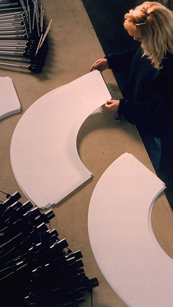 A person assembly the Costanza lamp.